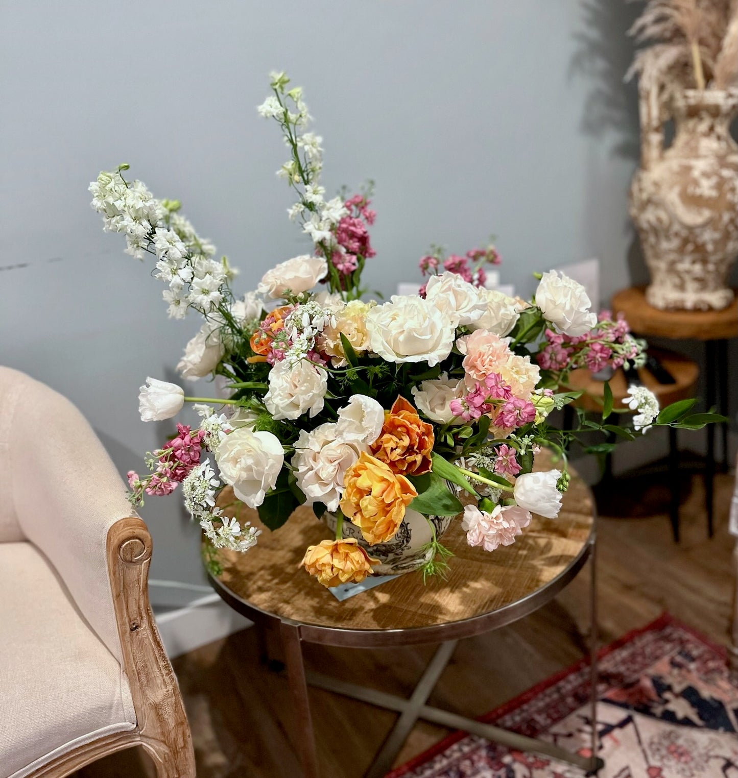 Large floral arrangement featuring Garden Roses, Hellebores, Tulips, Larkspur, Stocks, Carnations