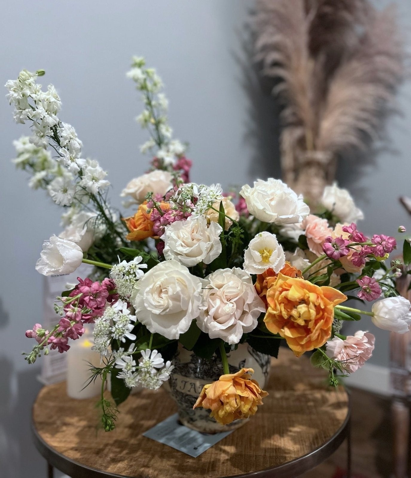 Large floral arrangement featuring Garden Roses, Hellebores, Tulips, Larkspur, Stocks, Carnations