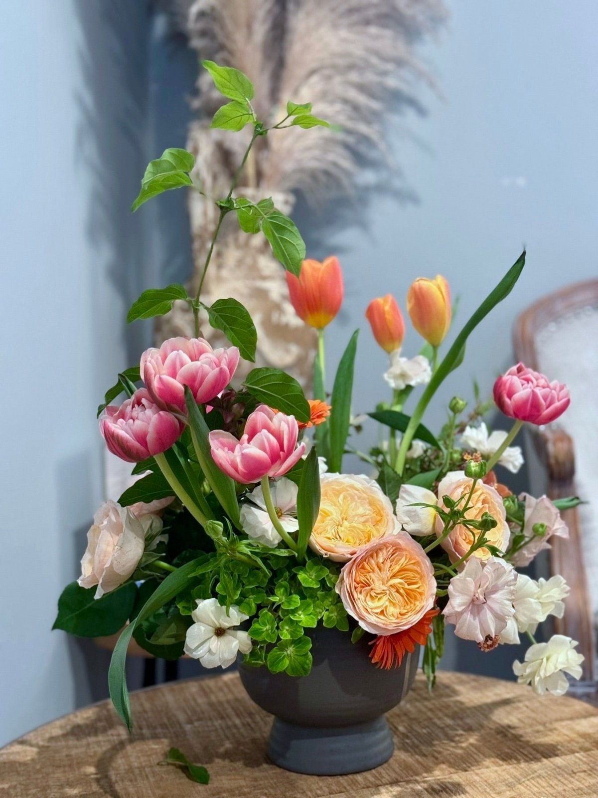 Large centerpiece featuring Garden Roses, Butterfly Ranunculus, Hellebores, Tulips, Gerberas